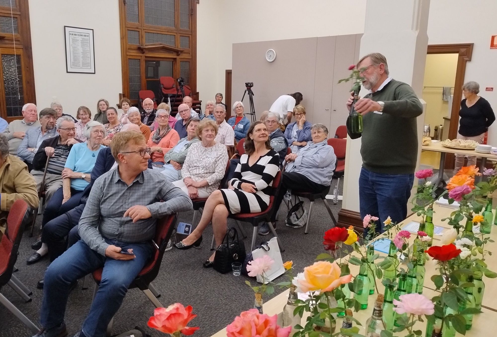 Merv Trimper judging roses at a Members meeting